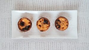 Three Egg Tarts on a Rectangular White Tray