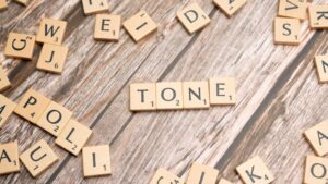 The word tone is spelled out in scrabble letters